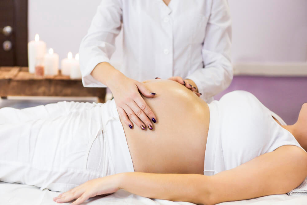 Midsection of woman lying on bed